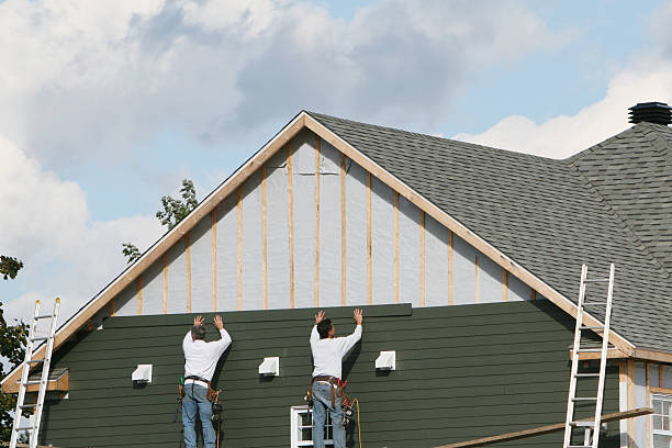 Professional Storm Damage Siding Repair technician working in Mansfield, PA